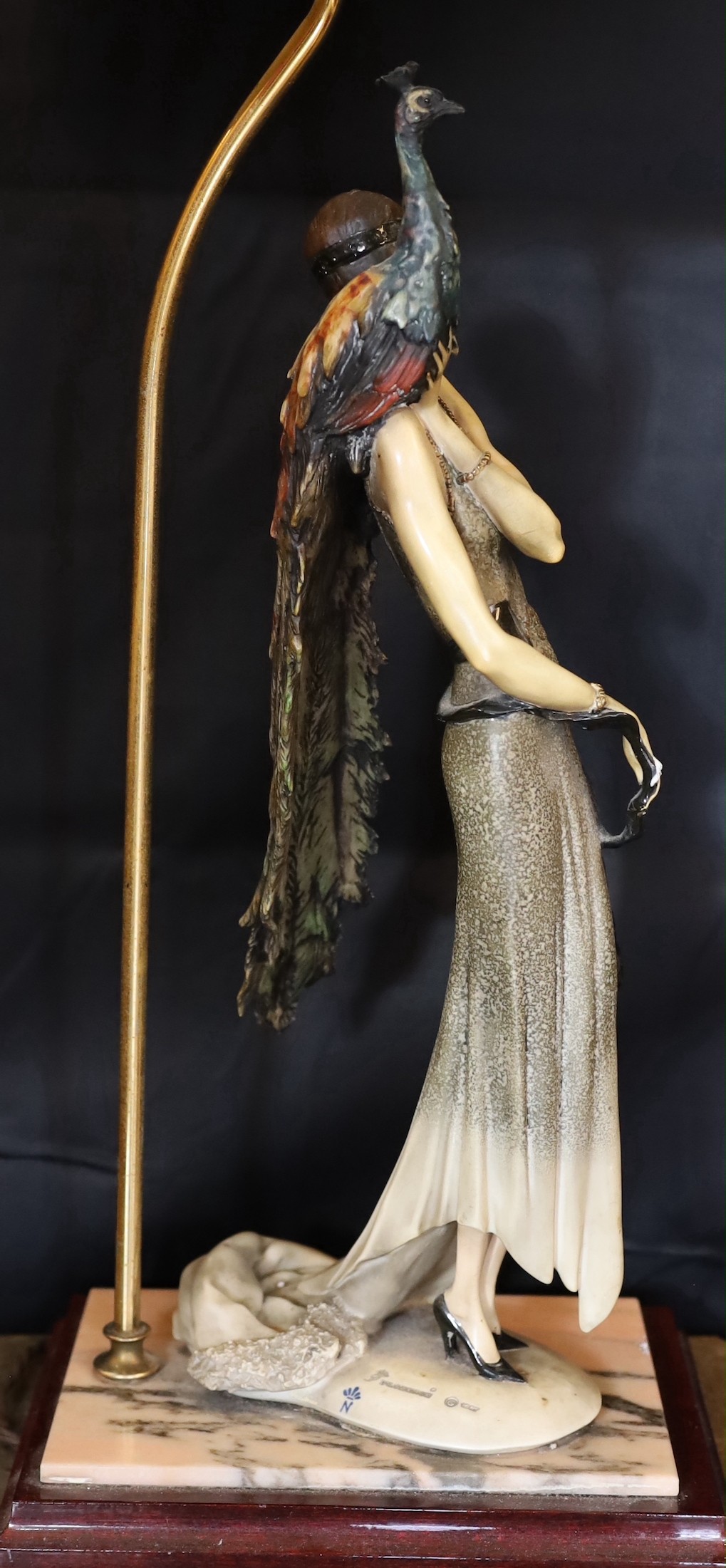 A 1980s Italian Giuseppe Armani lamp base, modelled with a resin lady holding a peacock, height 62cm, width of base 26cm